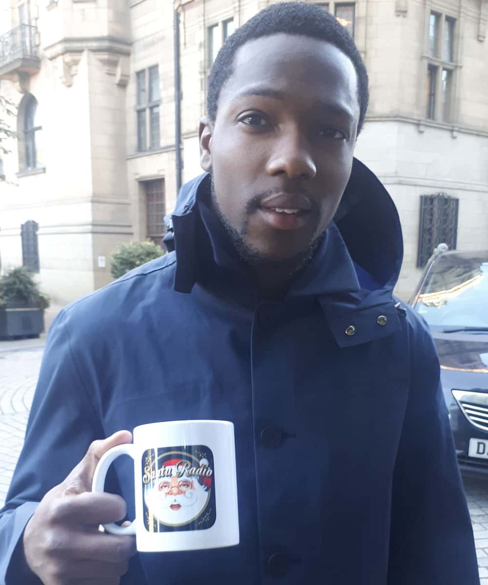 Tosin Cole with Santa Radio mug